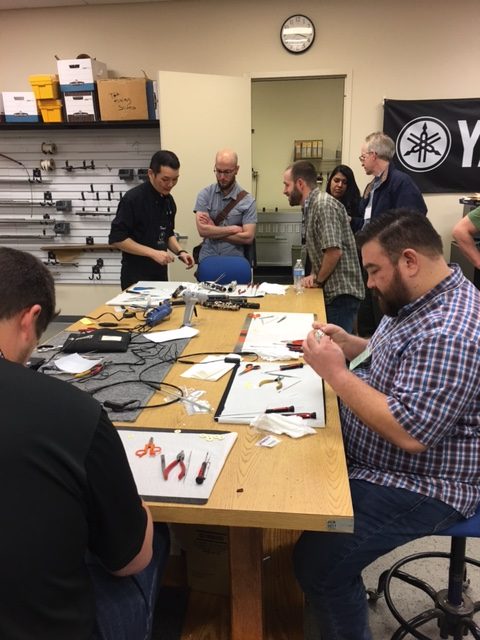 Technicians trying out some specialized Yamaha repair techniques.